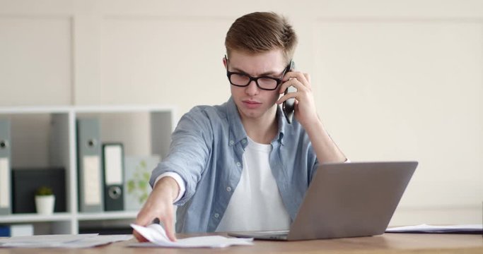 Emotional guy talking on cellphone with support manager