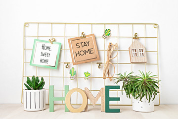 Mockup of mesh board with cards, eyeglasses, house plants. Stay home, home organisation, decoration, planning, slow living idea