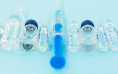 injection ampoules, syringe for vaccination on a blue background, healthcare coronavirus, cancer, painand treatment, pharmaceutical medicine concept .