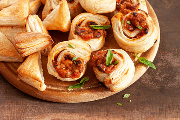 Assortment of burekas with cheese and tomato sauce