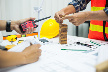 Architects and engineers brainstorm ideas and discuss the structural design of the building.