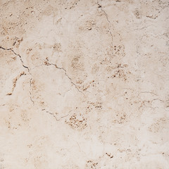 The cracked texture of the underside of a travertine tile