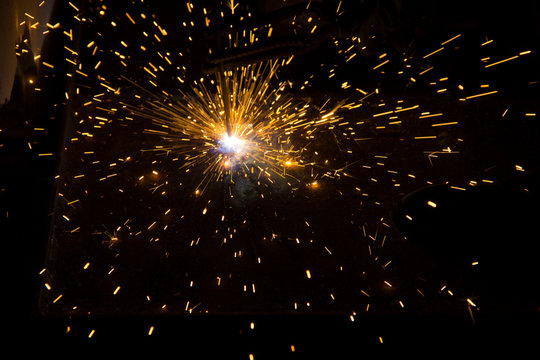 Beautiful sparks after contact of the welding electrode with the metal surface