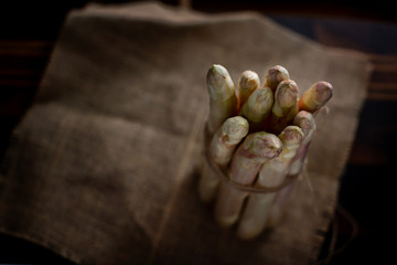 white asparagus tied with brown loose rope over a rustic background