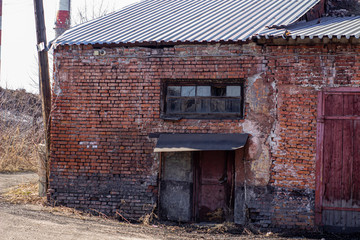 Fototapeta na wymiar Abandoned brick building in a ruined state