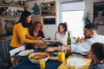 family gathering having dinner or lunch party at home