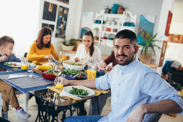 family gathering having dinner or lunch party at home. man posing