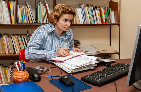 Image of a busy woman teleworking at her desk at the home. Working at home became an important recommendation during the coronavirus outbreak in the beginning of 2020
