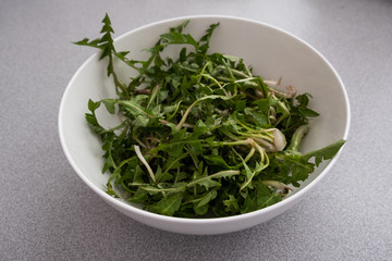 Fototapeta premium fresh green dandelion salad in a bowl