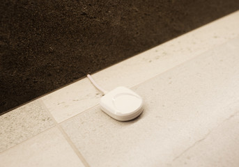 anti-flooding sensor on white floor in the bathroom