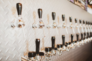 silver beer taps in the beer bar in perspective