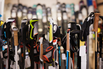 Large assortment of ski poles in foreground