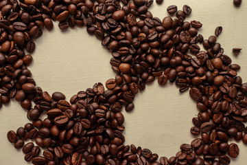 Coffee grains with space for text on brown paper background
