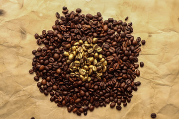 Golden and brown coffee grains on brown paper
