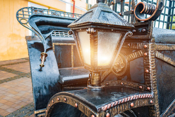 Iron vintage lantern on an old carriage
