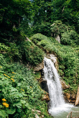 A small waterfall in the Park. Beautiful weather and view of the waterfall in the Park.