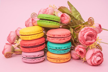 macarons with tender small roses. Sweets and desserts concept of macaroons