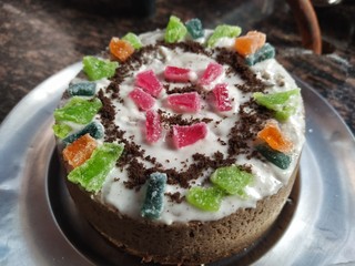 A decorated beautiful homemade cake  kept on a plate.