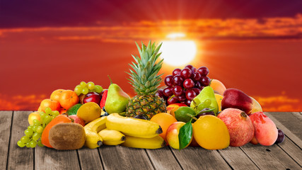 Naklejka na ściany i meble Sunset time and fresh fruits on wooden desk place