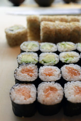 Sushi rolls with salmon, avocado and sesame seeds