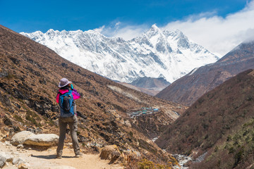 A trekker taking picture while trekking in Everest Base Camp, Himalaya mountains range in Nepal