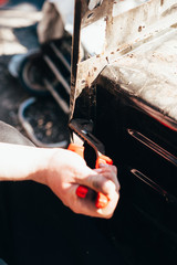man works with metal and tools