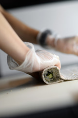 Rolling sushi with hands