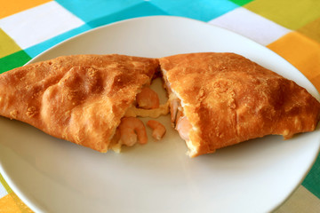 Plate of Empanada de Camarones or Shrimps and Cheese Filled Stuffed Pastry Cut in Half