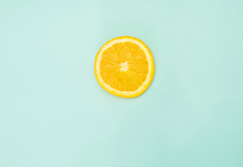 sliced orange on a bright green background