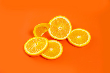 sliced orange on a bright orange background