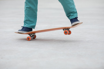 Fototapeta na wymiar Skateboarder legs skateboarding at outdoors