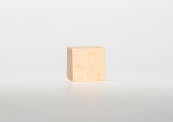 Design concept - abstract geometric real wooden cube with surreal layout on white floor background and it's not 3D render