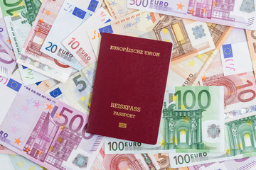 European passport lying on top of various Euro banknotes. Nationality, wealth, opportunity concept..