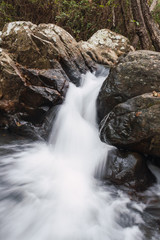 Obraz premium Small waterfall with slow motion effect between rocks