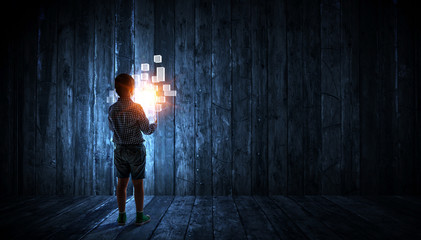 Fototapeta na wymiar Boy alone at night with glowing cubes