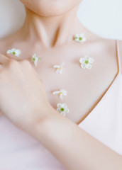 beautiful girl with flowers on the neck