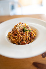 Spaghetti bolognese served on a white plate