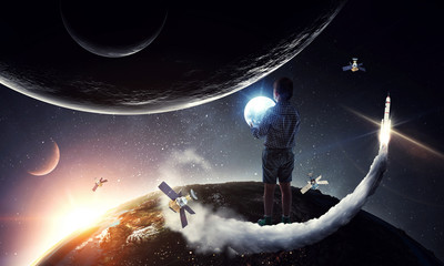 Obraz na płótnie Canvas Boy holding moon at night