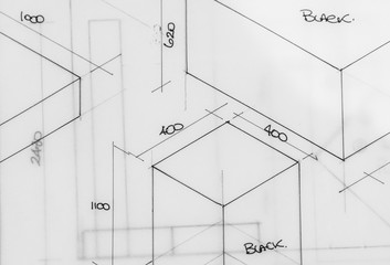 Photograph of a piece of tracing paper showing simple isometric technical drawings in black ink.