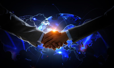 Business handshake by a man and a woman. Mixed media