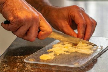Cooking at home during corona virus lockdown, cutting onions
