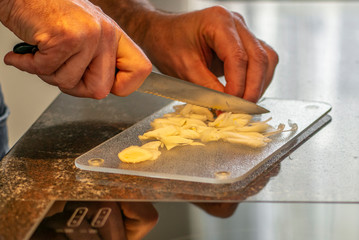 Cooking at home during corona virus lockdown, cutting onions