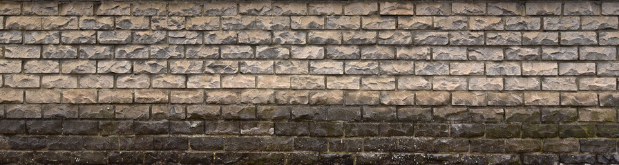 Old decorative brickwork on the basement of the building, destruction