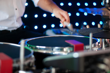 Drummer playing drum set at concert on stage. Music show. Bright scene lighting in club,drum sticks in hands.