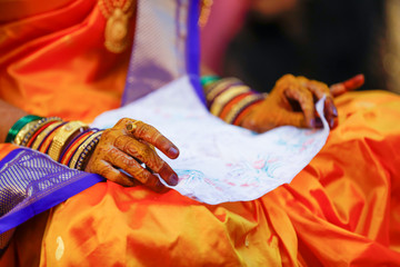 Indian wedding ceremony: bridal hand in haldi ceremony