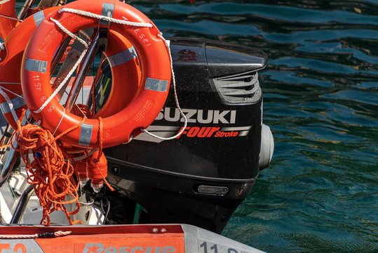 Close-up of a water ambulance, small motor boat for emergency first aid with orange lifebuoys and Four stroke Suzuki engine. Italy, Europe  