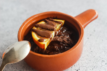 Delicious chocolate pudding with orange. Potted pudding on the table