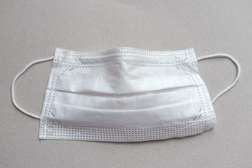 used medical face mask on the white background