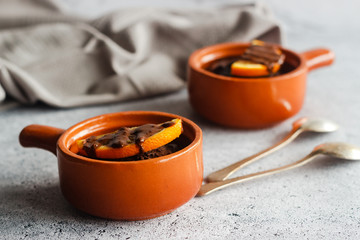 Delicious chocolate pudding with orange. Potted pudding on the table