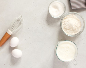  Ingredients for baking with flour and a culinary whisk with space for text, recipe. The concept of food